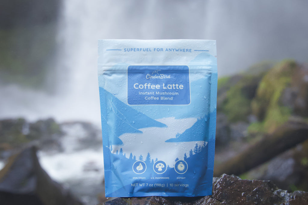 CinderBird Coffee Latte in front of a waterfall