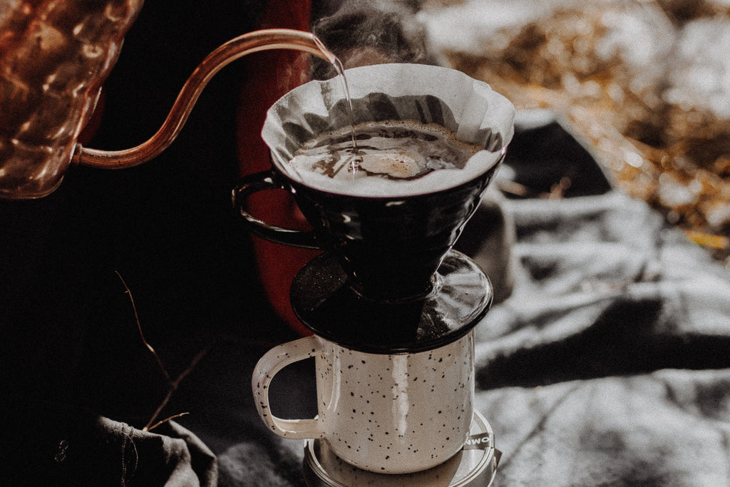 Pour over travel mug being used at camp