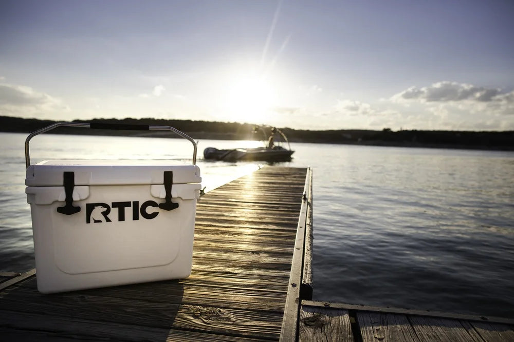 An Rtic cooler sitting on a dock