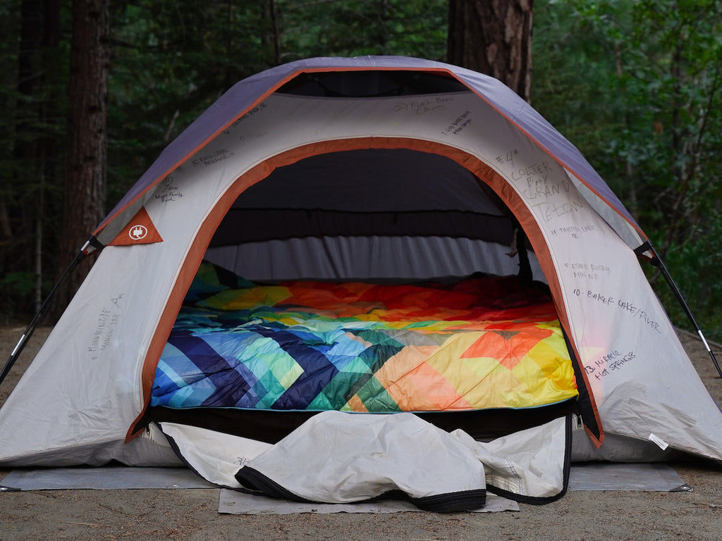 A tent bed set up with a Rumpl blanket