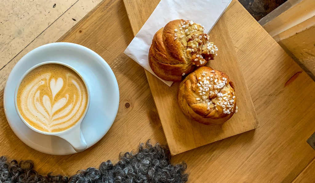 A cup of coffee and two Swedish pastries