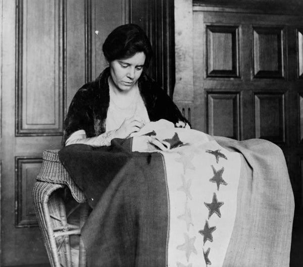 Alice Paul sewing a banner