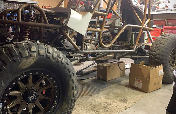 A vehicle built from scratch, parked in a garage.