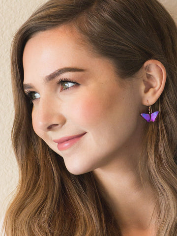 model wearing bella butterfly earrings
