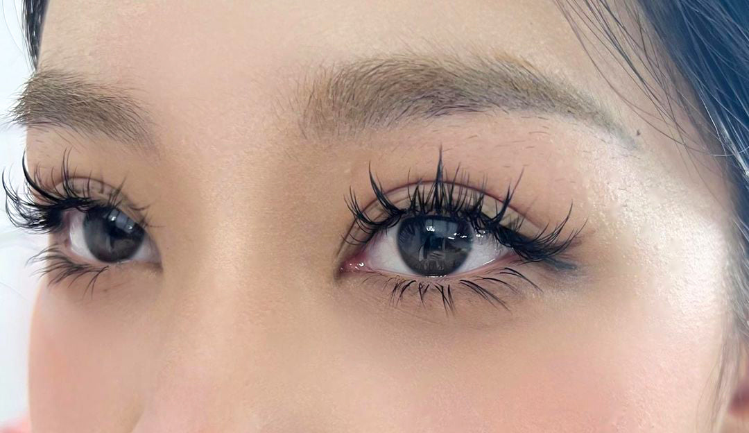 a woman sporting an 'Anime/Manga' lash style, portraying an exaggerated and expressive eye look reminiscent of anime and manga characters, achieved through lash extensions or makeup for a playful and artistic appearance