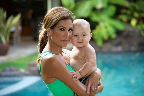 Desi Bartlett, MS CPT E-RYT Women’s Health Expert mom holding baby