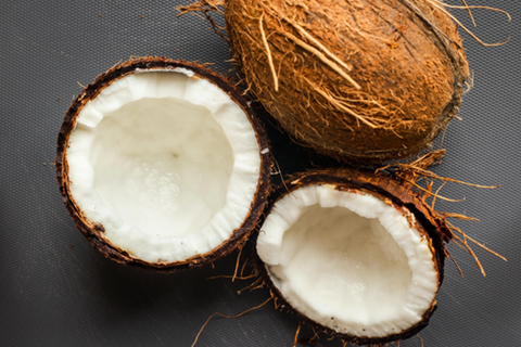 two coconut halves and one whole coconut