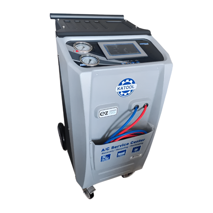 Overhead angle of the Katool R-1234YF Dual A-C Machine (KT-AC2100) highlighting its touchscreen controls, pressure gauges, and color-coded service hoses.
