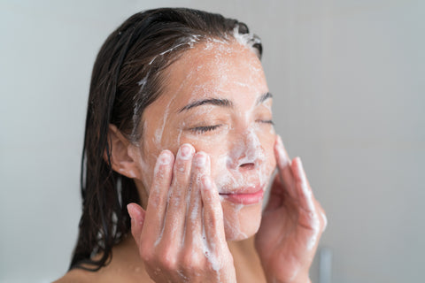 woman with sensitive skin washing face