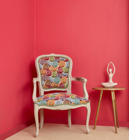 red sitting room with a patterned chair