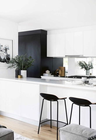 black and white kitchen timber floors and mirror splashback