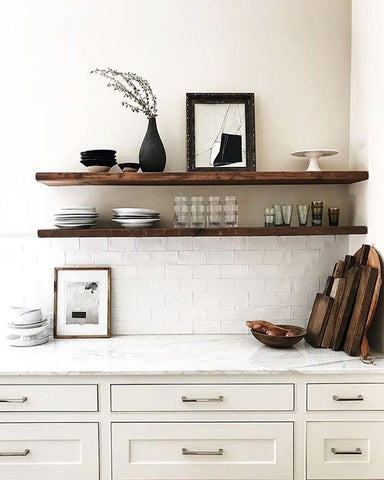 cream kitchen drawers, white bench subway tile splashback with wooden shelves