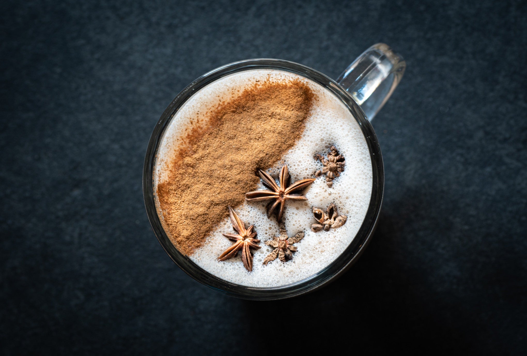 a hot cup of masala chai with cinnamon and garnished with star anise