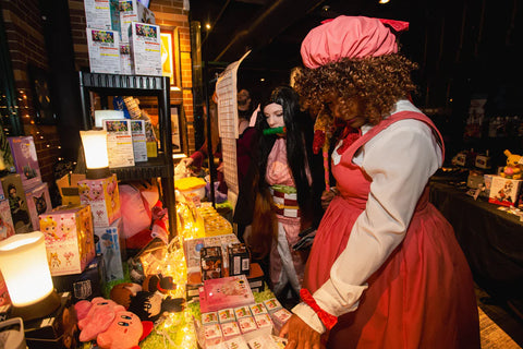 Cosplay attendees shopping at Kawaii Gifts vendor table
