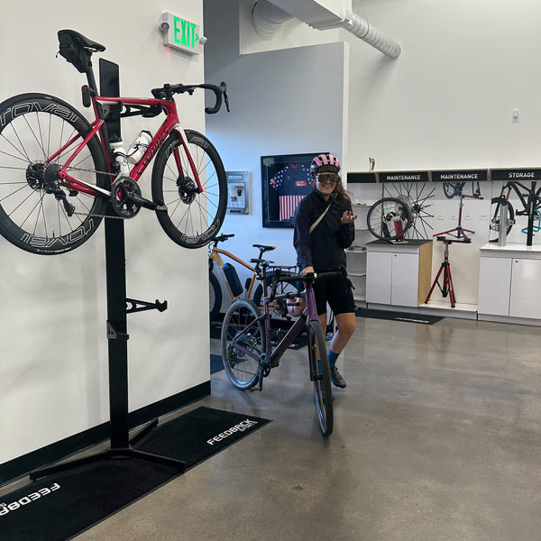 A person entering a sport themed office after biking to work.