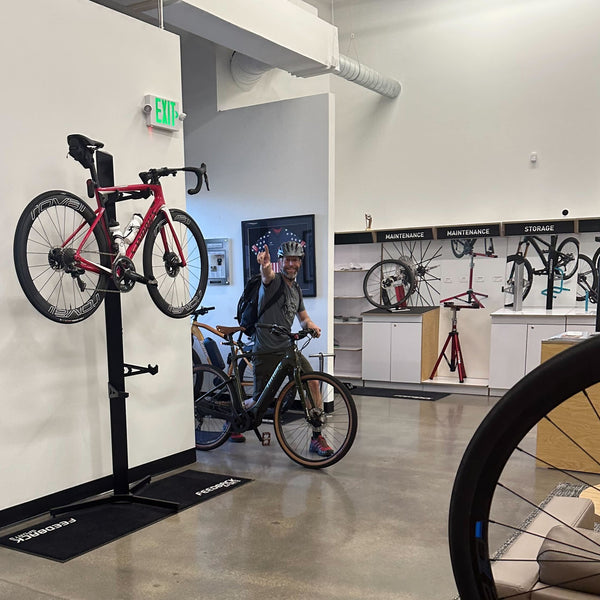 A person entering a sports-themed office after riding a bike to work.