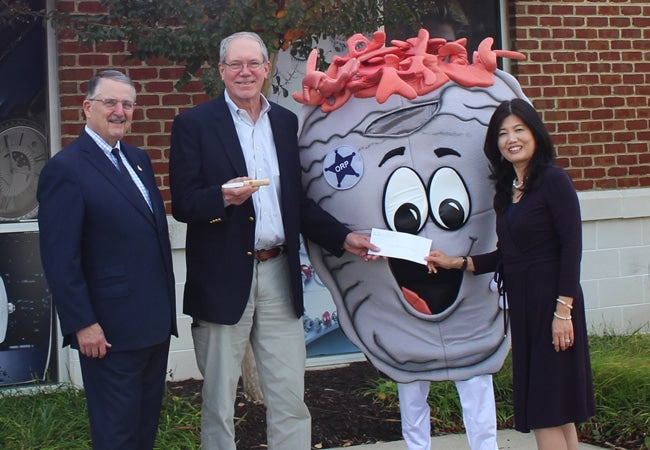 Steve and Linda Handing over Check to Oyster Recovery Foundation