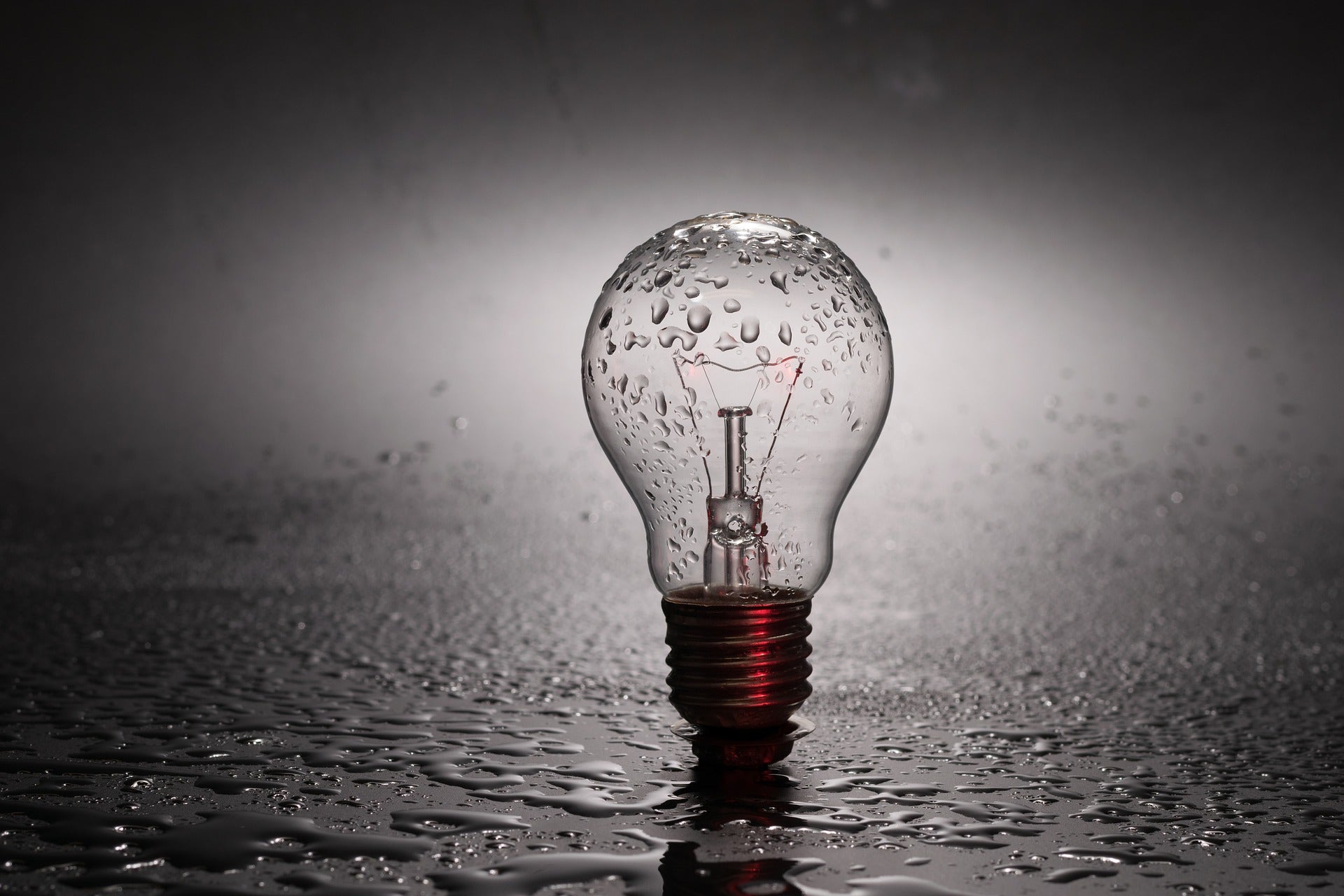 ampoule posée sur le sol à la verticale sous la pluie