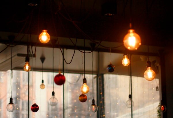 suspension filaire noire avec ampoules dénudées dans un bar