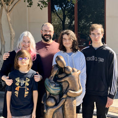 Elizabeth and her family next to the sculpture "Babywearing Family" they inspired!