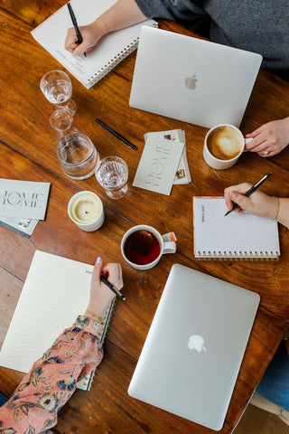 team meeting with laptop and coffee