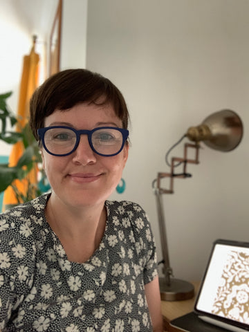 Artist Bryony Hall sitting at her workdesk