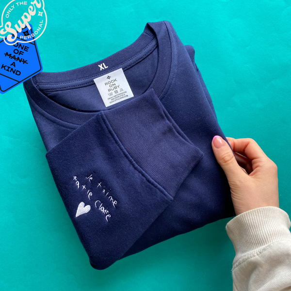 navy blue sweatshirt with white embroidery on the cuff with personalised handwriting
