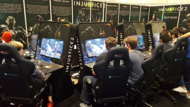 injustice 2 arcade machines at an expo