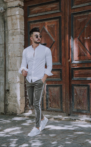 guy wearing a white shirt and grey pants