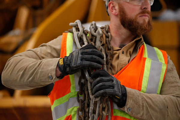 Someone working with black mpact gloves