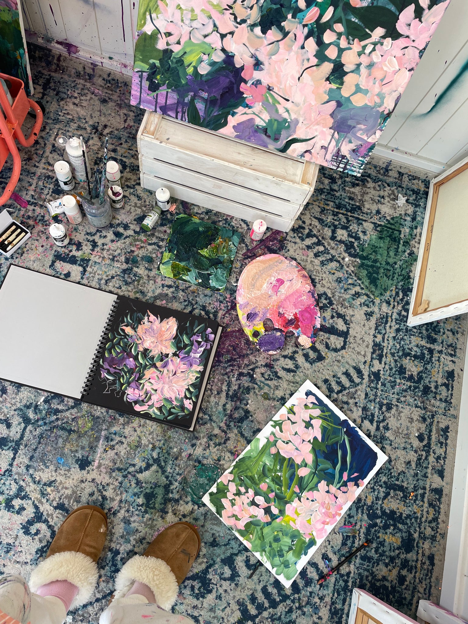 artist studio with paintings on the floor