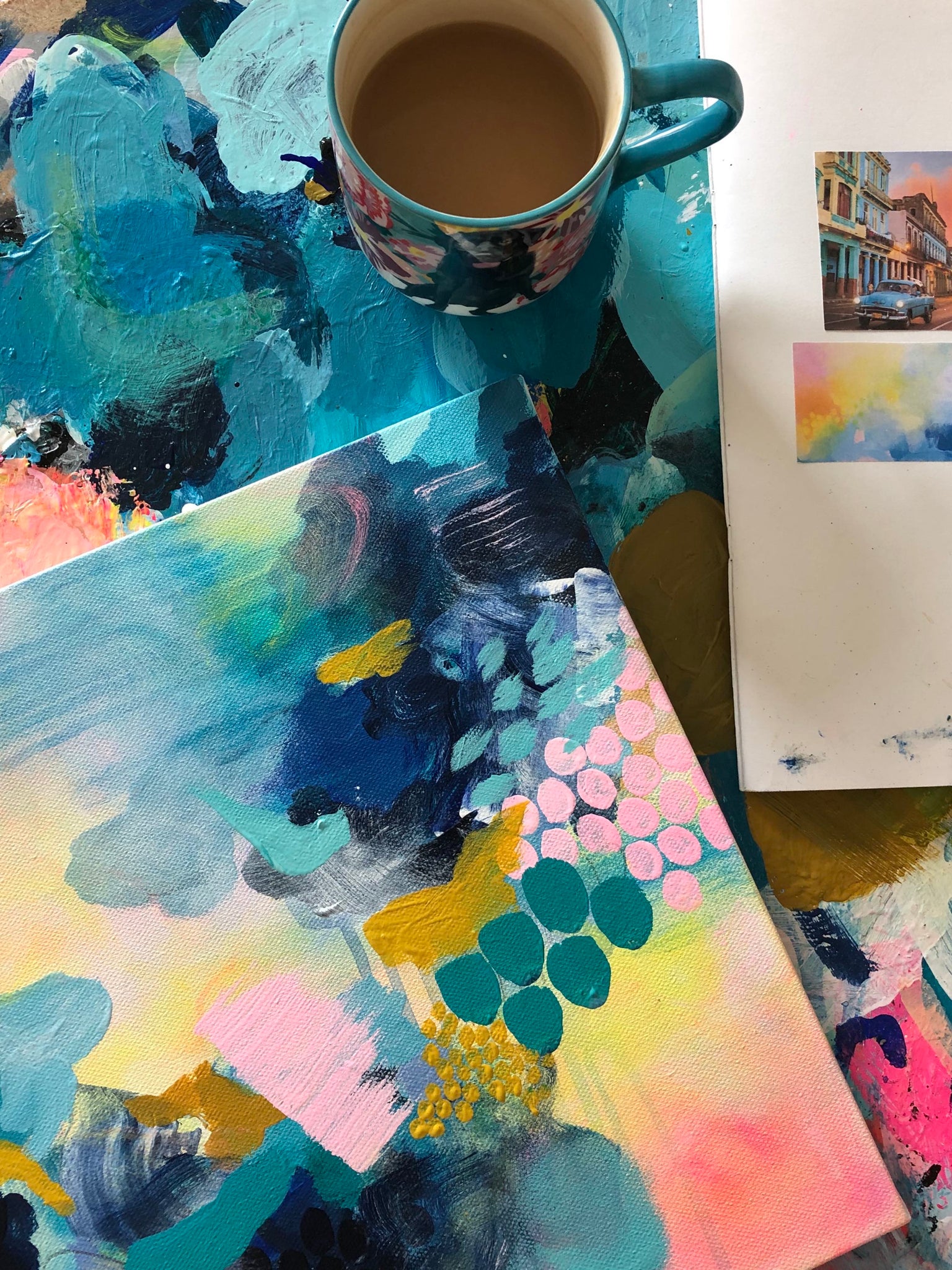 abstract painting with cup of tea and moodboard
