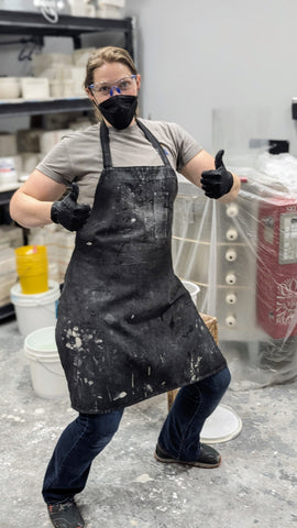 Person wearing personal protective equipment - safety googles, mask, apron and gloves