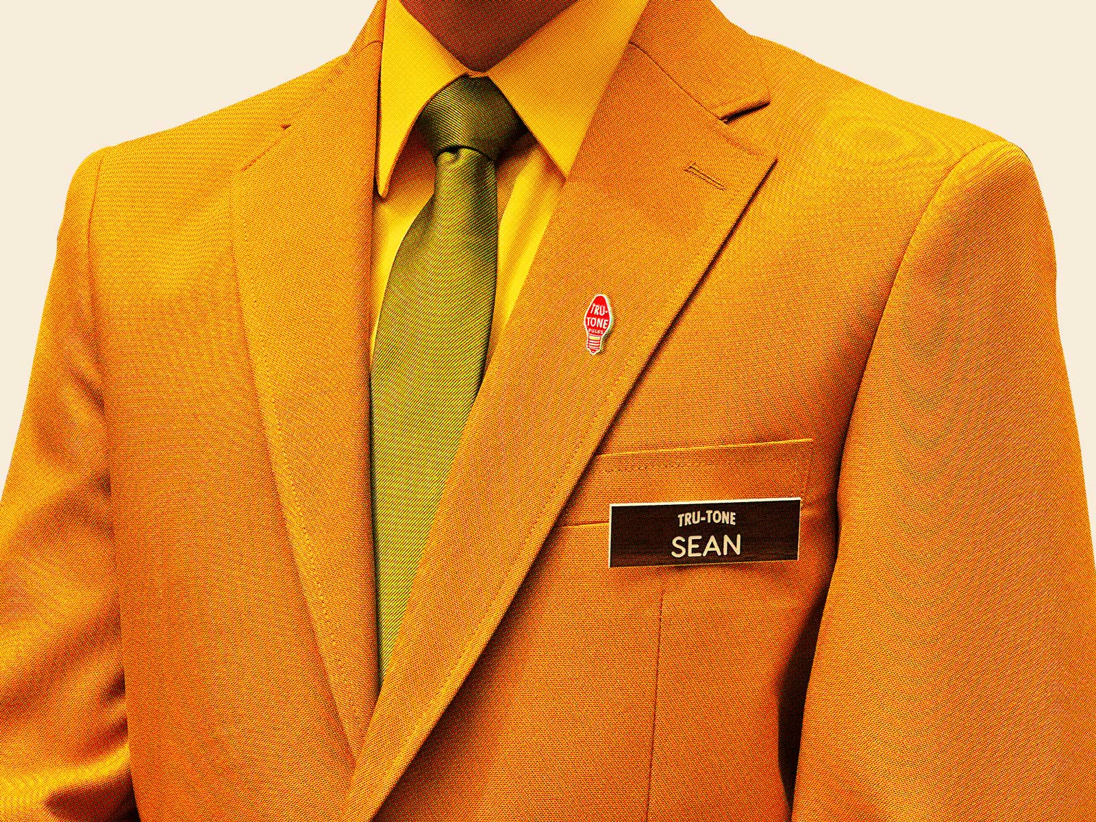 Golden blazer with Tru-Tone pin and employee name tag