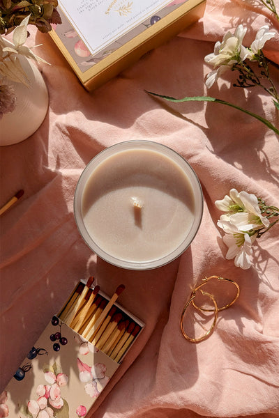 The Lakehouse Candle shot from above on pink background with matches