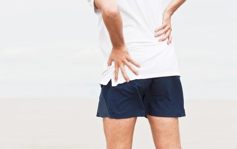 Man holding is lower back from back pain