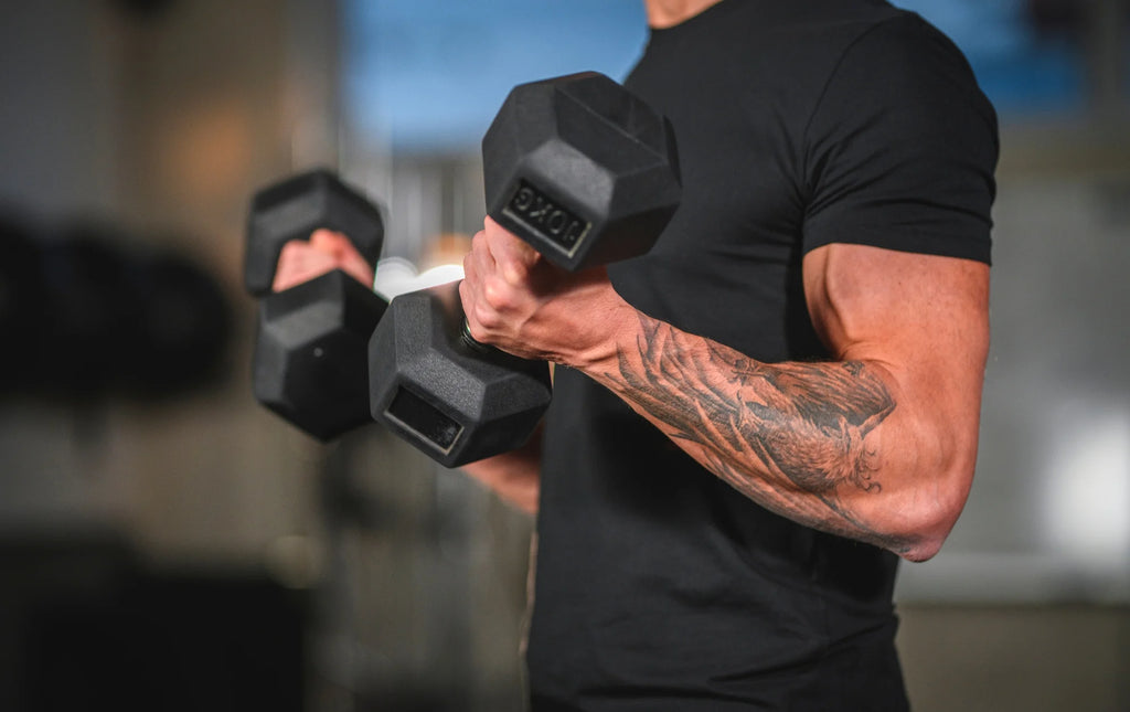 Man holding hex dumbbells