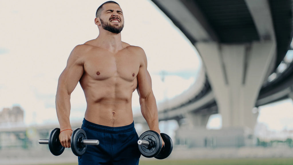 Man straining to train with dumbbells feature Image