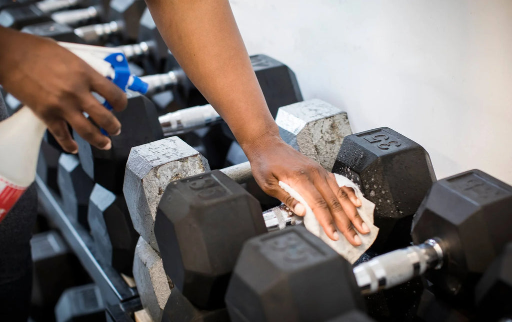 sterilizing and cleaning dumbbells in a gym