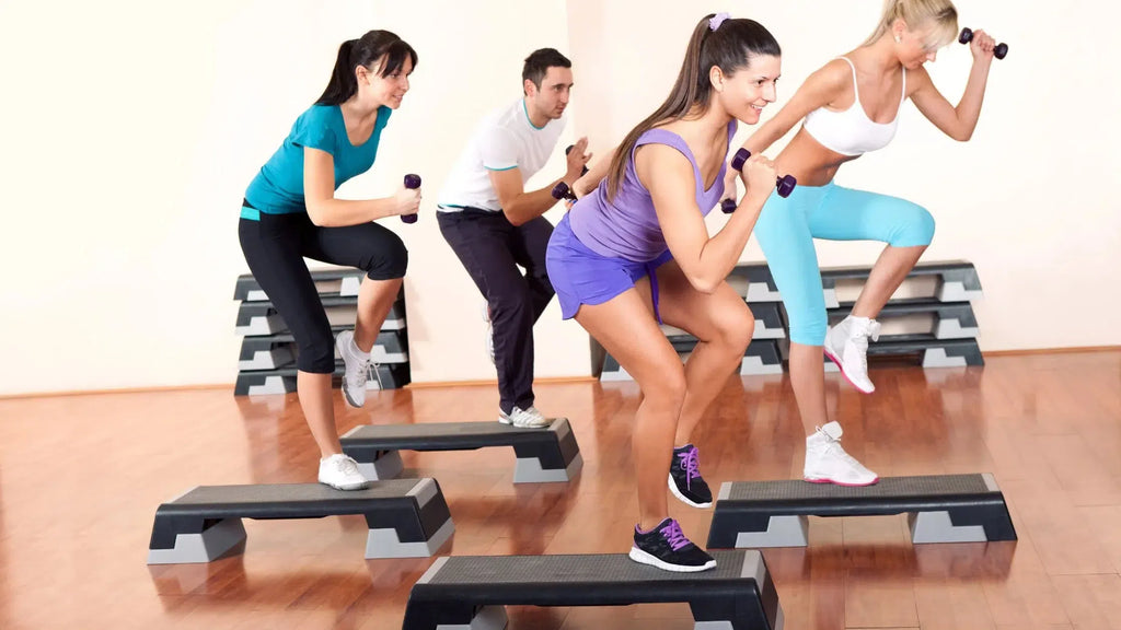 step aerobics class with vinyl dumbbells