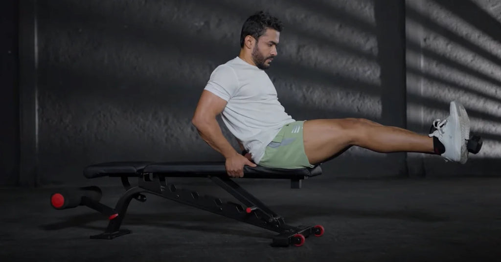 man doing seated dumbbell leg extensions on a weight bench