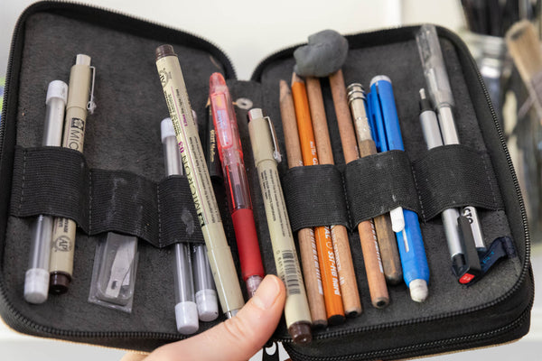 Pens and pencils in a case