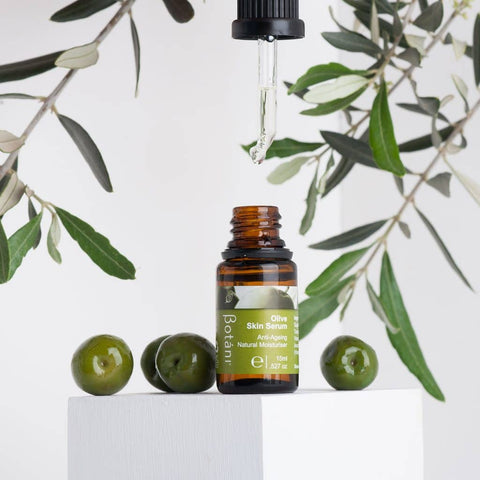 Olive Skin Serum Dripping from the Dropper, featuring fresh Olives.