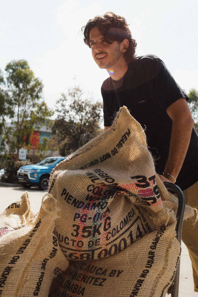 Jack pushing coffee sacks on trolley