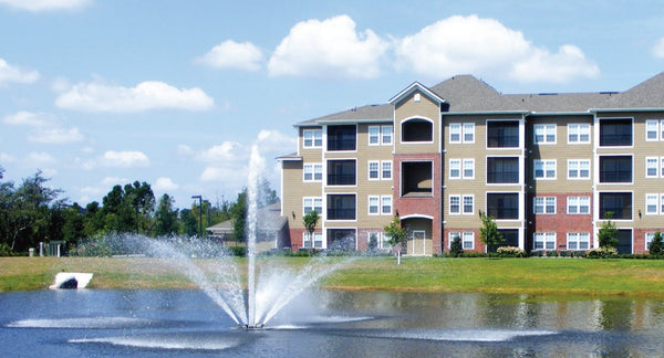 Vertex FanJet Floating Fountain Series On Water Display With Apartment On Background