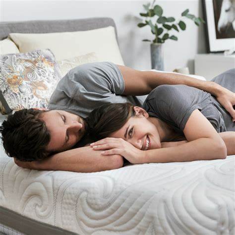 Women smiling, couple on mattress