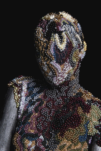 Closeup of the intricate pattern on the front portrait of the Queen of Pearls sculpture."