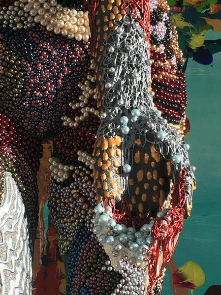 Closeup of the hand of the Queen of Pearls sculpture, highlighting the intricate pearls and stunning 3D effect.