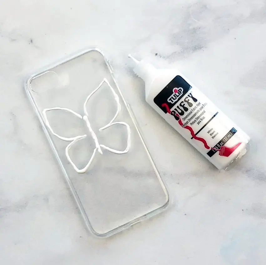 Outline butterfly in White Dimensional Fabric Paint on clear case