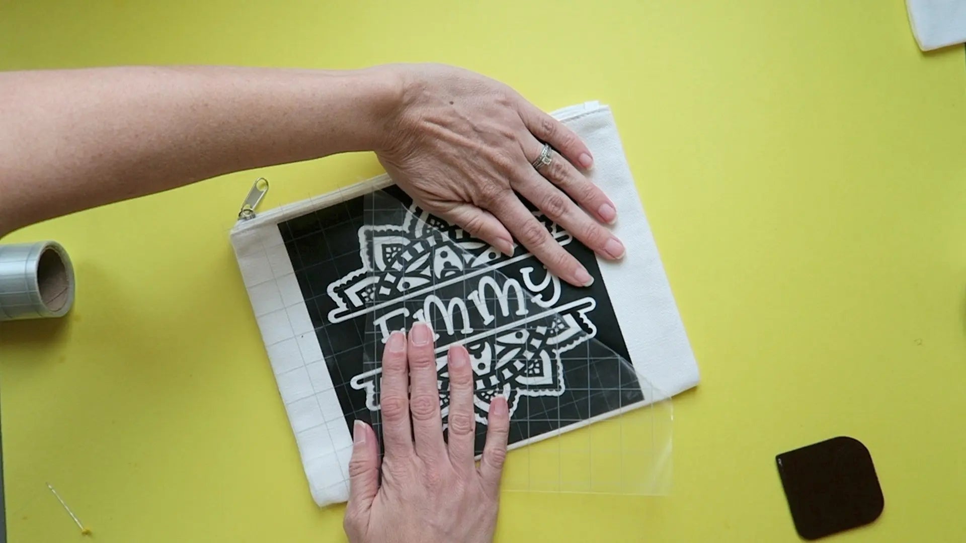 Use masking or painter's tape to attach your stencil in desired placement on pencil pouch.